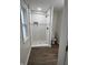 Modern bathroom with a large walk-in shower and wood-look flooring at 3919 E 34Th St, Indianapolis, IN 46218