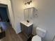 Updated bathroom with vanity and toilet, gray cabinetry at 3919 E 34Th St, Indianapolis, IN 46218