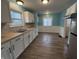 Modern kitchen with white cabinets, new flooring, and stainless steel appliances at 3919 E 34Th St, Indianapolis, IN 46218