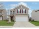 Two-story house with gray siding, burgundy shutters, and a white garage door at 4086 Lassen Ln, Indianapolis, IN 46235