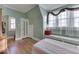 Bedroom featuring hardwood floors, soft green walls, a window seat, and a twin bed at 550 W Jefferson St, Franklin, IN 46131