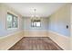 Empty dining room with floral wallpaper, a chandelier, and carpeted floors at 5621 Sugar Hills Dr, Greenfield, IN 46140