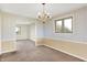 Empty dining room with floral wallpaper, chandelier, and carpeted floors at 5621 Sugar Hills Dr, Greenfield, IN 46140