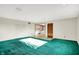 Living room with green carpet, white walls, and a view into the kitchen at 5621 Sugar Hills Dr, Greenfield, IN 46140