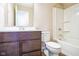 Clean bathroom with white bathtub, toilet, and dark brown vanity at 610 Atlas Dr, Lebanon, IN 46052