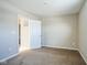 Bedroom with carpet, door to bathroom, and window at 610 Atlas Dr, Lebanon, IN 46052