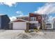 Two-story home with red and beige exterior, snow-covered lawn, and attached garage at 610 Atlas Dr, Lebanon, IN 46052