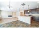 Open concept kitchen with island, stainless steel appliances, and dark brown cabinets at 610 Atlas Dr, Lebanon, IN 46052