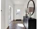 Bright entryway with hardwood floors, console table, and mirror at 613 Waterford Ln, Westfield, IN 46074