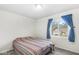 Bedroom with blue curtains, carpeted floors, and a large window with neighborhood views at 67 Apple Tree Cir, Fishers, IN 46038