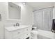 Updated bathroom with white vanity and bathtub at 7317 Lions Head Dr # D, Indianapolis, IN 46260