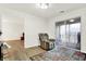 Sitting room with hardwood floors, recliner, and sliding glass door to patio at 7317 Lions Head Dr # D, Indianapolis, IN 46260