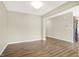 Open dining area with wood-look flooring and neutral walls at 7755 Rolling Green Dr, Plainfield, IN 46168