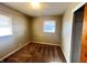 Empty bedroom with carpeted floors, two windows, and closet at 7835 E 50Th St, Indianapolis, IN 46226