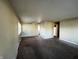 Inviting living room with carpeted flooring, a ceiling fan, and neutral-colored walls at 7835 E 50Th St, Indianapolis, IN 46226