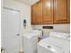 Laundry room with washer, dryer, and wood cabinets at 1036 Laurelwood Ln, Greenwood, IN 46142