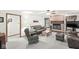 Living room with a brick fireplace, leather seating, and a ceiling fan at 1110 N Cambridge Ct, Greenfield, IN 46140