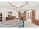 Main bedroom featuring wooden furniture, carpeted flooring, and access to a bathroom at 1110 N Cambridge Ct, Greenfield, IN 46140