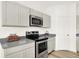 Kitchen with stainless steel appliances and gray countertops at 11710 Cotterill Way, Indianapolis, IN 46235