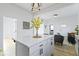 View of the kitchen island with white cabinets, pendant lighting, and an open concept layout at 1176 Udell St, Indianapolis, IN 46208