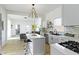 Bright, updated kitchen featuring white cabinets, an island with seating, and stainless steel appliances at 1176 Udell St, Indianapolis, IN 46208