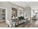 Elegant dining room with statement art and a live edge table at 1490 Chatham Village Blvd, Westfield, IN 46074