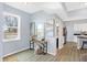 Open concept living room with light blue walls, a console table, and hardwood floors at 16185 E 281St St, Atlanta, IN 46031