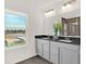 Double vanity bathroom with dark countertop and large window at 1867 Vista Ridge Dr, Greenwood, IN 46143