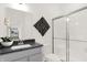 Clean bathroom with gray vanity, modern shower, and decorative accents at 1867 Vista Ridge Dr, Greenwood, IN 46143