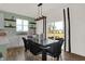 Bright dining area with backyard view and modern black table and chairs at 1867 Vista Ridge Dr, Greenwood, IN 46143