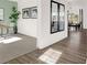Sunlit entryway with hardwood floors and mirrors reflecting dining area at 1867 Vista Ridge Dr, Greenwood, IN 46143