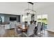 Bright dining room features a rustic wood table with gray chairs and a modern chandelier at 19728 Patcham Rd, Westfield, IN 46074