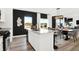 White kitchen with an island, stainless steel appliances, and dark-colored accent wall at 2783 Linwood Ave, Greenwood, IN 46143