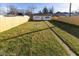 Fenced backyard with detached garage and grassy area at 401 N Chester Ave, Indianapolis, IN 46201