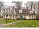 Brick ranch house with brown roof, white shutters, and landscaped lawn at 4205 Cranbrook Dr, Indianapolis, IN 46250