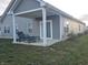 Gray house with covered patio, seating, and grill at 4411 Ringstead Way, Indianapolis, IN 46235