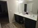 Double vanity bathroom with gray flooring and a shower at 4411 Ringstead Way, Indianapolis, IN 46235