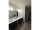 Double vanity bathroom with gray flooring and a shower at 4411 Ringstead Way, Indianapolis, IN 46235