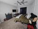 Main bedroom with a king bed, desk, and ceiling fan at 4411 Ringstead Way, Indianapolis, IN 46235