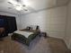 Spacious bedroom with large bed, wall paneling, and ceiling fan at 4411 Ringstead Way, Indianapolis, IN 46235