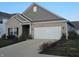 Brick and gray siding ranch home with a white garage door at 4411 Ringstead Way, Indianapolis, IN 46235