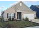 Brick ranch house with landscaping and a two-car garage at 4411 Ringstead Way, Indianapolis, IN 46235