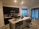 Modern kitchen with dark cabinets, granite counters, and an island at 4411 Ringstead Way, Indianapolis, IN 46235
