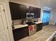 Dark wood kitchen cabinets and granite countertops with stainless steel appliances at 4411 Ringstead Way, Indianapolis, IN 46235