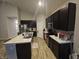 Open concept kitchen with dark cabinetry and granite countertops at 4411 Ringstead Way, Indianapolis, IN 46235