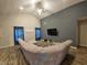 Spacious living room featuring a sectional sofa and large TV at 4411 Ringstead Way, Indianapolis, IN 46235