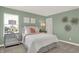 Bedroom with green walls, a queen bed, and stylish decor at 4412 Chital Pl, Greenwood, IN 46143