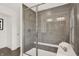 Modern walk-in shower with gray tile and a built-in seat at 4412 Chital Pl, Greenwood, IN 46143