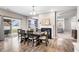 Dining room with a six-chair table, hardwood floors, and access to the backyard at 4585 W Tradwell Dr, New Palestine, IN 46163