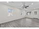 Living room with wood-look flooring, abundant natural light, and access to other areas at 5410 Bertha St, Indianapolis, IN 46241